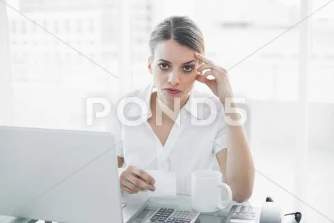 Unhappy businesswoman working sitting at her desk Stock Photos