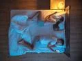 The unhappy couple with smartphone lay on the bed. night time. view from abov Photo