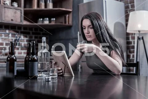 Unhappy depressed woman looking at the photo Stock Photos