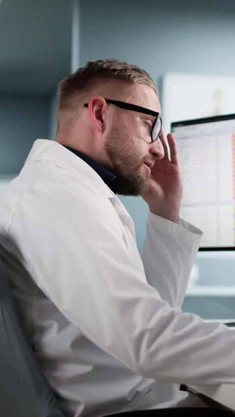 Unhappy Doctor Frustrated Using Boring Medical Spreadsheet Stock Footage 320767242