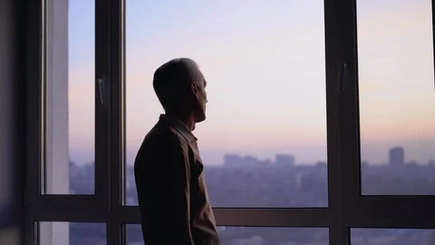 Unhappy elderly man looking in window, feeling lonely in city, sad memories Stock Footage 122041133