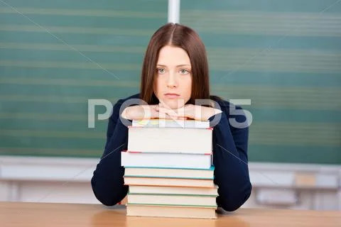 Unhappy female student with her books Stock Photos