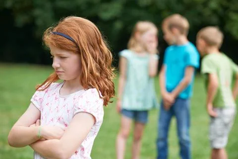 Unhappy Girl Being Gossiped About By Other Children Stock Photos