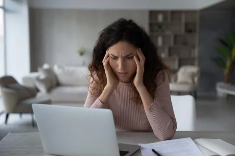 Unhappy Latino woman distressed with work deadline Stock Photos