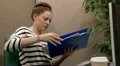 Unhappy stressed teenage office worker searching files HD Footage