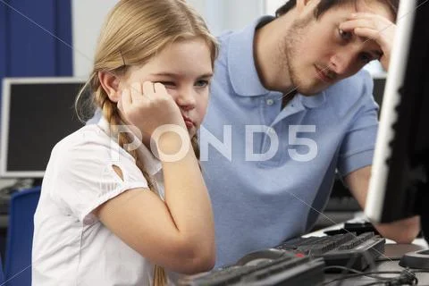 Unhappy teacher and girl using computer in class Stock Photos