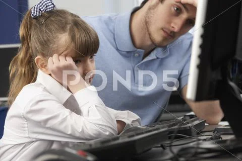 Unhappy teacher and girl using computer in class Stock Photos