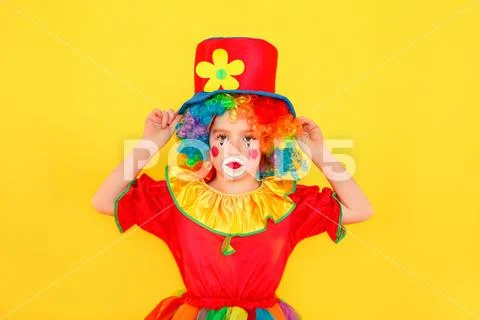 Unhappy tired little clown looking at camera Stock Photos