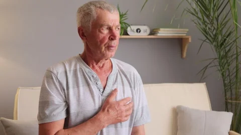 Unhappy unhealthy gray haired man wearing casual clothing feeling pain . Видео 252761753