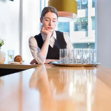 Unhappy waitress at work Fotos Stock