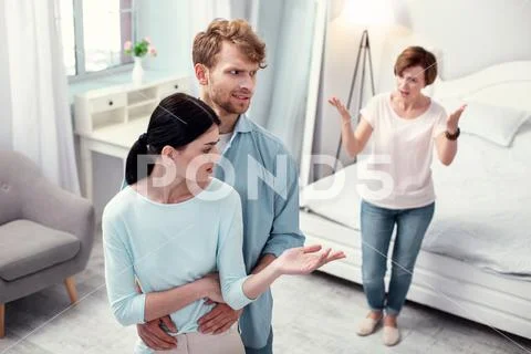 Unhappy young couple listening to the mother in law Stock Photos