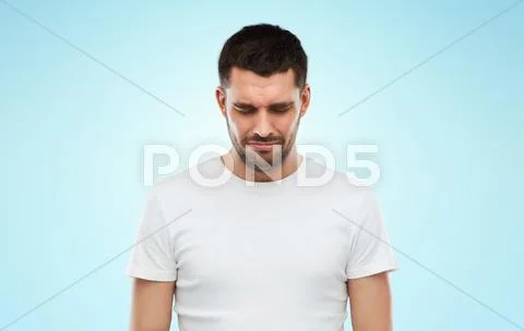 Unhappy Young Man Over Blue Background