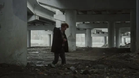 Unhappy Young Man Staggering while Walking under Bridge and Smoking Stock Footage 284258301