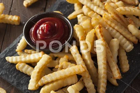 Unhealthy Baked Crinkle French Fries Stock Photos