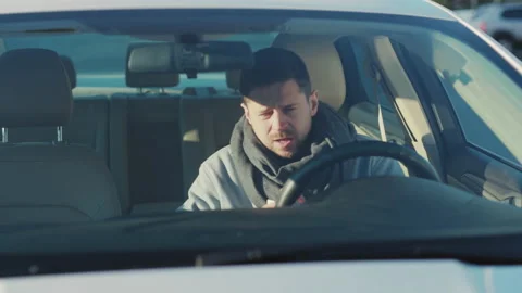 Unhealthy business guy getting inside car. Sick unwell caucasian bearded man Stock Footage 164986429