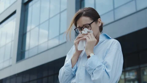 Unhealthy woman sneezing blowing her nose into paper napkin, seasonal allergy Stock Footage 248770719