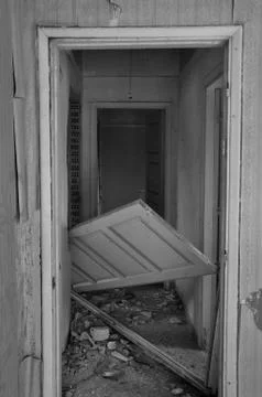 Unhinged door abandoned house Stock Photos