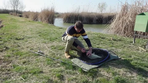 Unhooking a fish on a carp mattress Stock Footage 210238021