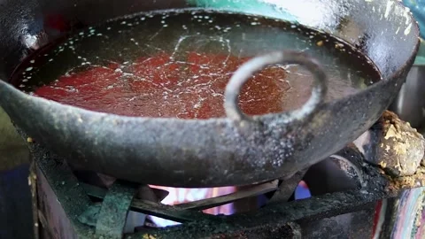 Unhygienic multiple time used boiling oil on gas burner at street shop Stock Footage 247620711