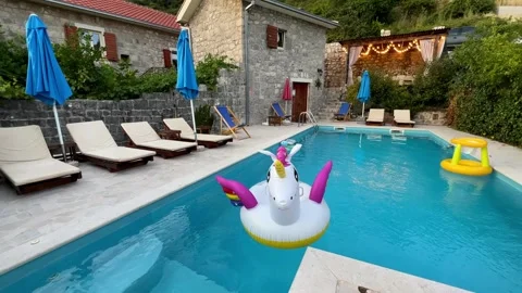 A unicorn float is peacefully drifting in the water of a swimming pool Stock Footage 268726269