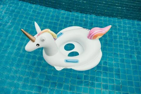 Unicorn pool float in blue water in pool Stock Photos