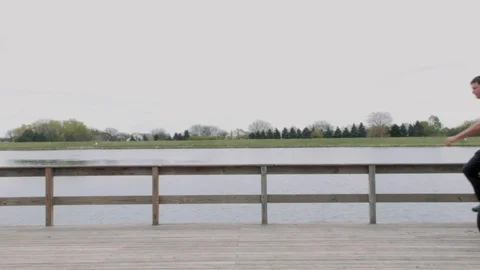 Unicycle Ride By A Lake Stock Footage 90054513
