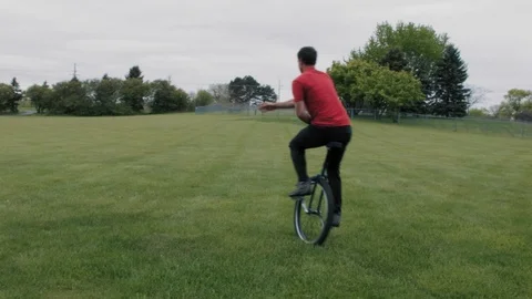 Unicycle Ride in a Park Video stock 90054634