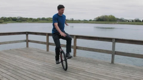 Unicycling on a Deck Stock Footage 90054580