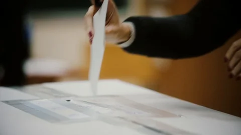 Unidentifiable person casting a ballot during elections Stock Footage