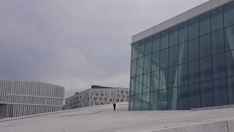 Unidentifiable person stands on top of the opera house in Oslo. Version 1 Stock Footage 291985953