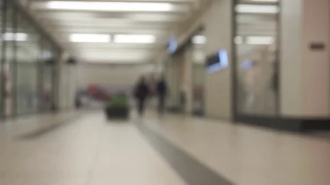 Unidentifiable,unrecognizable,out of focus people going through shopping mall Stock Footage 74016624
