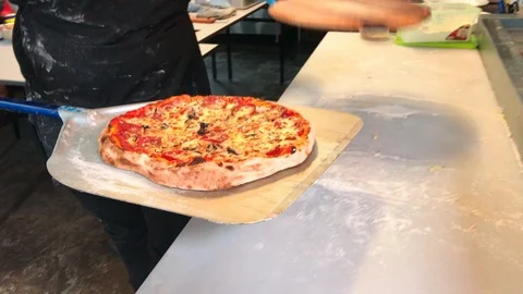 Unidentified chef transferred a well-cooked handmade pizza Видео 105587271