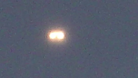 Unidentified flying object with glowing lights in dark sky Stock Footage 336874193