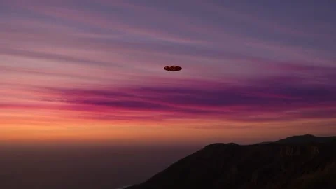 Unidentified flying object soaring over mountain silhouette at sunset 4K Stock Footage 340154176