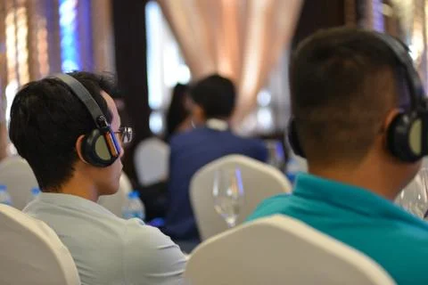 Unidentified peoples are wearing interpreter's headset Stock Photos