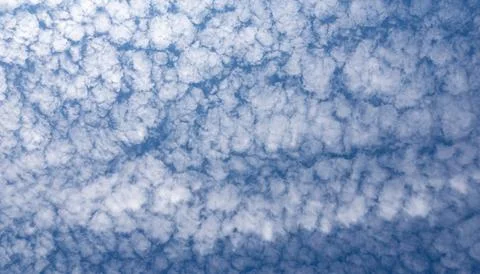 Uniform altocumulus cloud pattern over deep blue sky ideal for background use Stock Photos