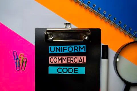 Uniform Commercial Code (UCC) text on sticky notes with color office desk Stock Photos