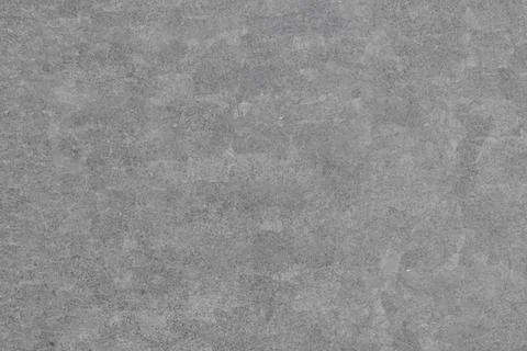 A uniform gray background featuring a subtly rough, mottled texture with sl.. Stock Photos