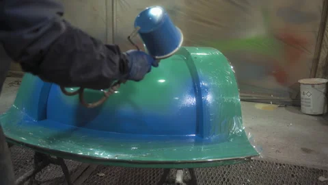 Uniform Worker Sprays Spray Paint from Spray Gun on Structure in Paint Chamber Stock Footage 158903220