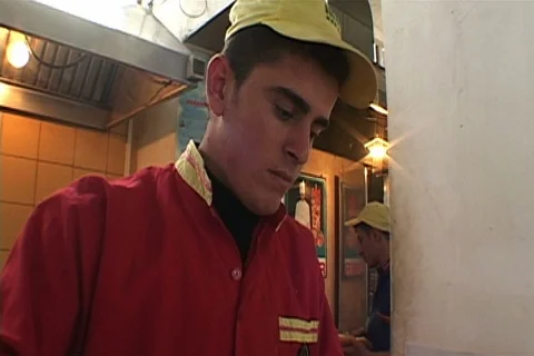 Uniformed MaDonal's worker prepares hamburger. Stock Footage 86753567