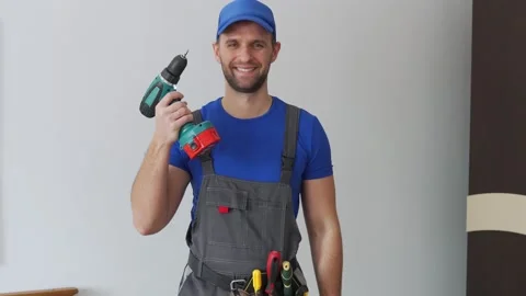 Uniformed maintenance worker holds a screwdriver and looks at the camera Stock Footage 151140705