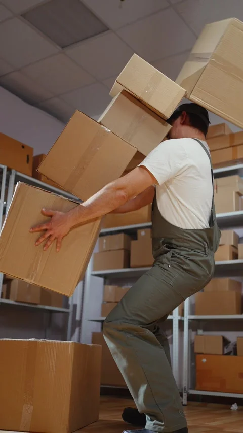 Uniformed mover falls with boxes of failure vertical video Stock Footage 275241912