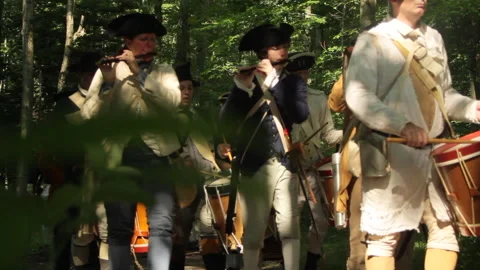 Uniformed Rev War Re-enactor Soldiers Marching through thick wilderness Stock Footage 170392690