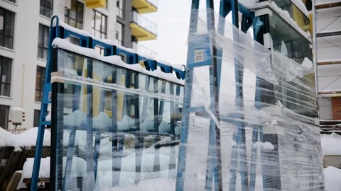 An uninstalled double-glazed window is packed and wrapped in film outdoor in Stock Footage 258679315
