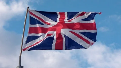 Union Flag / Union Jack / Flag with wind and blue sky / clouds. Video stock 77011744