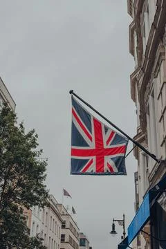 Union Jack British flag on a pole outside a store on Bond Street, London, UK. Stock Photos