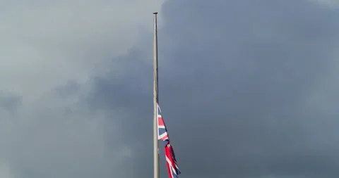 Union Jack Flag In Cornwall Half-masted Against Dramatic Sky Following The Stock Footage 209448721