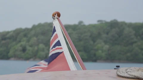 Union Jack Flag Flapping in the Wind, Stern of the Boat in Devon, England Stock Footage 246561171