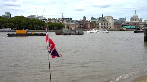 A Union Jack flag flying near boats on the River Thames, London. Video stock 80455037