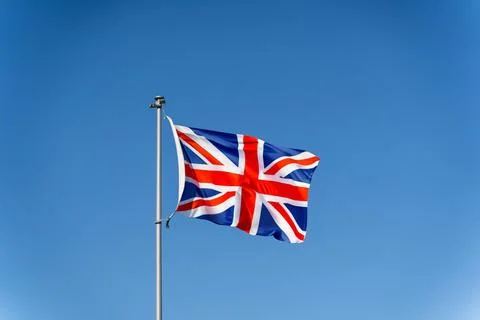 Union Jack Flag of Great Britain against a Blue Sky Stock Photos